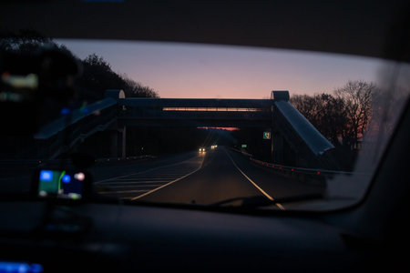 view through the windshield of the car on the road at night i