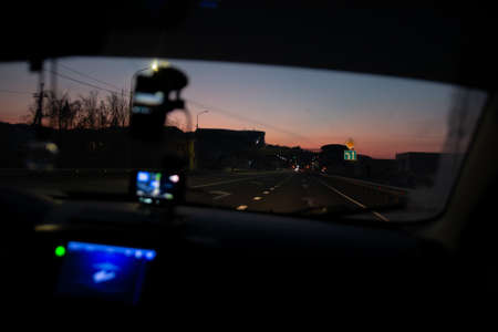 view through the windshield of the car on the road at night iの写真素材