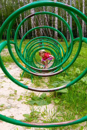 girl playing in the playground in summer