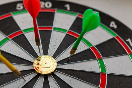 Litecoinc cryptocurrency in the center of darts. Right on target.の写真素材