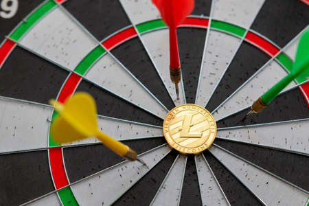 Litecoinc cryptocurrency in the center of darts. Right on target.の写真素材