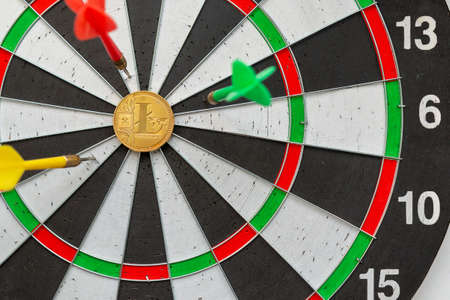 Litecoinc cryptocurrency in the center of darts. Right on target.の写真素材