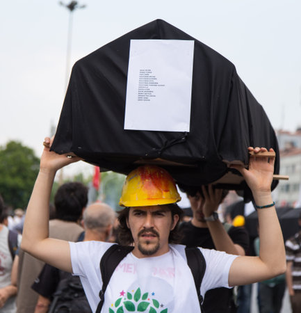 ISTANBUL, TURKEY - MAY 25, 2014: Man with replica coffin in march in protest against subcontractors in Turkey.のeditorial素材