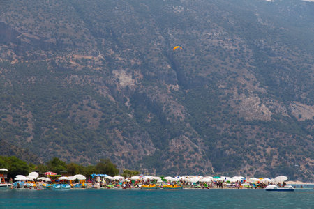 OLUDENIZ, MUGLA, TURKEY - JULY 19, 2014: People enjoying summer in Oludeniz beach. Oludeniz is one of the most famous beach in Turkey and also conjunction point of the Aegean and Mediterranean seas.のeditorial素材