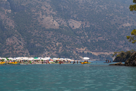 OLUDENIZ, MUGLA, TURKEY - JULY 19, 2014: People enjoying summer in Oludeniz beach. Oludeniz is one of the most famous beach in Turkey and also conjunction point of the Aegean and Mediterranean seas.のeditorial素材