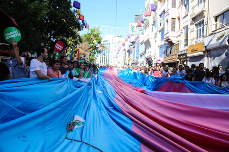 ISTANBUL, TURKEY - JUNE 21, 2015: People carry LGBT flag during Istanbul Trans Pride March in Istiklal Avenue at the beginning of Istanbul LGBT Pride Week.のeditorial素材