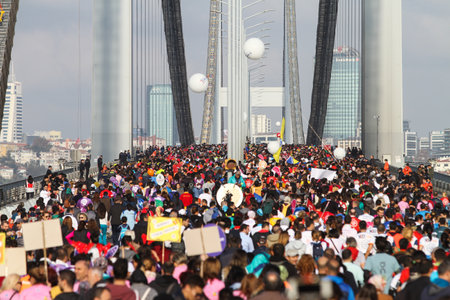 ISTANBUL, TURKEY - NOVEMBER 15, 2015: People are crossing the Bosphorus Bridge from Asia to Europe during 37th Istanbul Marathon. More than 100000 people attended to marathon, 15K, 10K and fun run.のeditorial素材