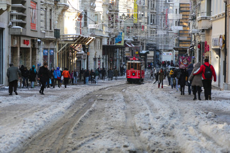 ISTANBUL, TURKEY - JANUARY 01, 2016: Historic red tram carrying people on Istiklal Avenue. Red tram is one of the symbol of Istanbul, trams started to work on 1869 in Istanbul.のeditorial素材