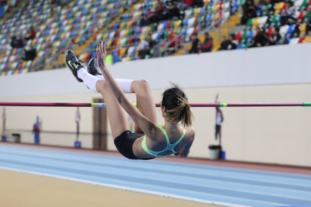 ISTANBUL, TURKEY - FEBRUARY 21, 2016: Athlete Merve Menekse high jumps during Turkcell Turkish Indoor Athletics Championshipsのeditorial素材