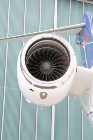 Engine of a white business jet on ground