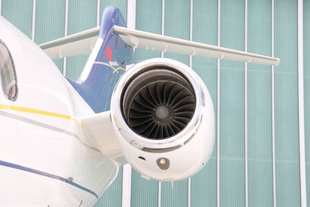 Engine of a white business jet on groundの写真素材