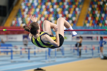 ISTANBUL, TURKEY - FEBRUARY 05, 2017: Athlete Rumeysa Oktem high jumping during Turkcell Turkish Youth Indoor Championshipsのeditorial素材
