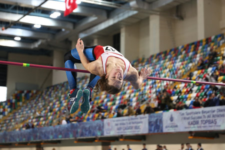 ISTANBUL, TURKEY - FEBRUARY 04, 2017: Athlete Enes Can Bayraktaroglu high jumping during Turkcell Turkish Youth Indoor Championshipsのeditorial素材