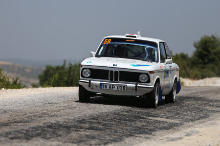 CANAKKALE, TURKEY - JULY 02, 2017: Ibrahim Ozturk drives BMW 1502 in Rally Troiaのeditorial素材