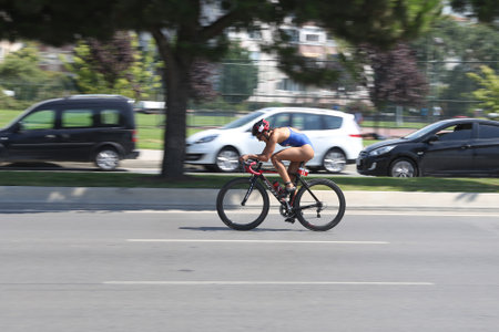 ISTANBUL, TURKEY - AUGUST 13, 2017: Athlete competing in cycling component of Istanbul Kartal Triathlon.のeditorial素材