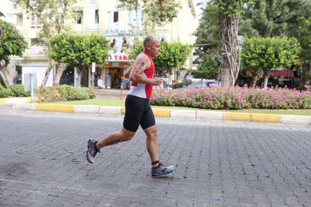 ANTALYA, TURKEY - SEPTEMBER 30, 2017: Athlete competing in running component of Alanya Triathlon.のeditorial素材
