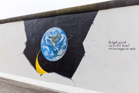 BERLIN, GERMANY - DECEMBER 16, 2017: Mural painted over Berlin Wall in East Side Gallery where the largest open air gallery in the worldのeditorial素材