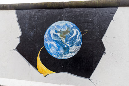 BERLIN, GERMANY - DECEMBER 16, 2017: Mural painted over Berlin Wall in East Side Gallery where the largest open air gallery in the worldのeditorial素材