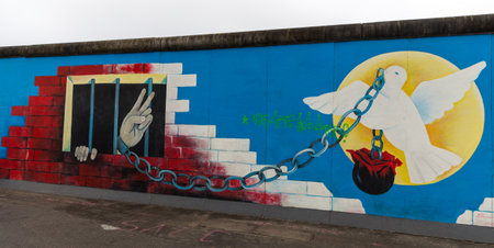 BERLIN, GERMANY - DECEMBER 16, 2017: Mural painted over Berlin Wall in East Side Gallery where the largest open air gallery in the worldのeditorial素材