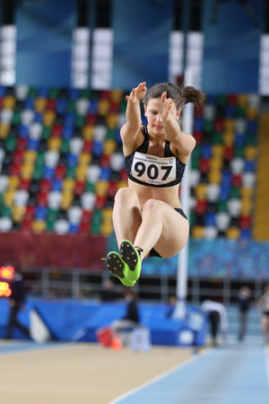 ISTANBUL, TURKEY - JANUARY 28, 2018: Undefined athlete long jumping during Turkcell Turkish U20 Indoor Athletics Championshipsのeditorial素材