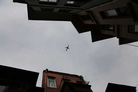 Airplane passing over Fener District in Istanbul City, Turkeyの写真素材