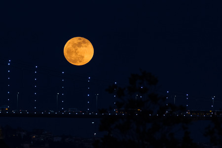 Super Blue Blood Moon Behind Bosphorus Bridge in Istanbul City, Turkeyの写真素材