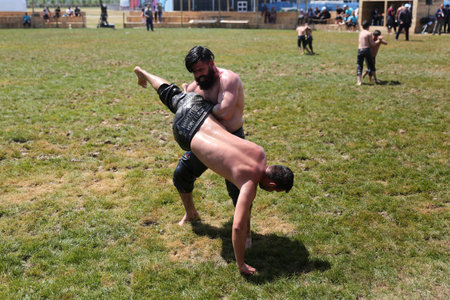 ISTANBUL, TURKEY - MAY 12, 2018: Oil wrestlers compete during Etnospor Culture Festival. Oil wrestling also called grease wrestling is the Turkish traditional sport.のeditorial素材
