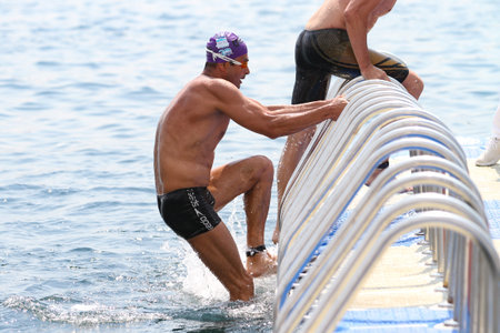ISTANBUL, TURKEY - JULY 22, 2018: Swimmer in finish of Samsung Bosphorus Cross Continental Swimming Competition in Bosphorus Strait.のeditorial素材