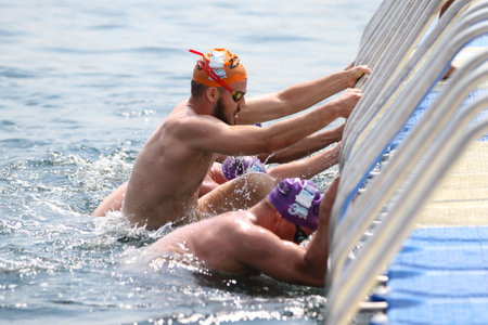 ISTANBUL, TURKEY - JULY 22, 2018: Swimmer in finish of Samsung Bosphorus Cross Continental Swimming Competition in Bosphorus Strait.のeditorial素材