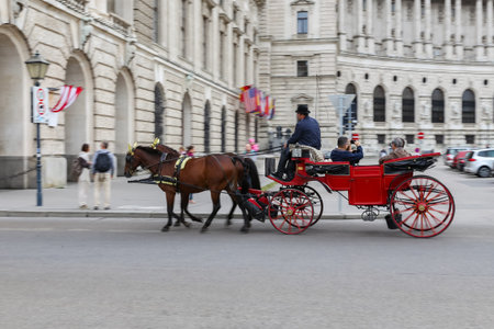 VIENNA, AUSTRIA - AUGUST 26, 2018: People touring in Coach in Hofburg palace
