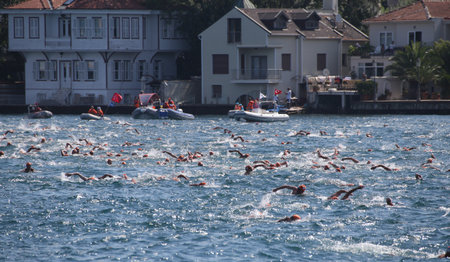 ISTANBUL, TURKEY - JULY 21, 2019: Swimmers crossing Bosphorus Strait during Samsung Bosphorus Cross Continental Swimming Competition.のeditorial素材