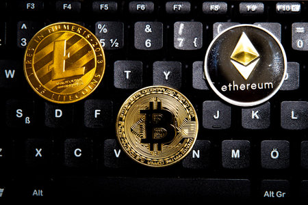 Cryptocurrency Bitcoin, Litecoin and Ethereum on a Black Keyboard