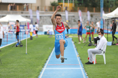 ISTANBUL, TURKEY - SEPTEMBER 13, 2020: Undefined athlete triple jumping during Balkan U20 Athletics Championshipsのeditorial素材