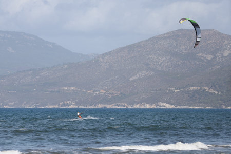 IZMIR, TURKEY - SEPTEMBER 27, 2020: Kitesurfer kitesurfing in Selcuk Pamucak Beachのeditorial素材
