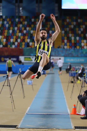 ISTANBUL, TURKEY - FEBRUARY 06, 2021: Undefined athlete long jumping during Turkish Indoor Athletics Championshipsのeditorial素材
