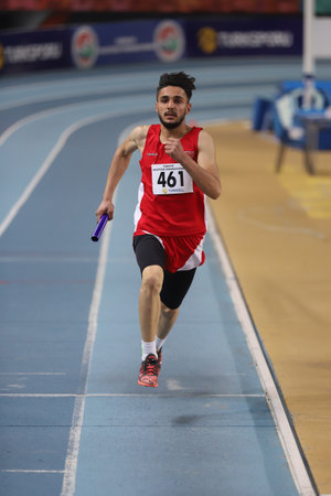 ISTANBUL, TURKEY - FEBRUARY 07, 2021: Undefined athlete running 4x400 metres relay during Turkish Indoor Athletics Championshipsのeditorial素材