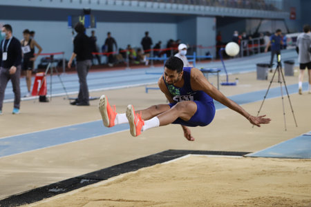 ISTANBUL, TURKEY - FEBRUARY 06, 2021: Undefined athlete long jumping during Turkish Indoor Athletics Championshipsのeditorial素材