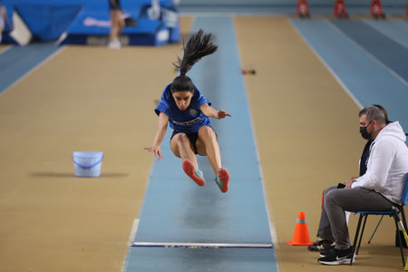 ISTANBUL, TURKEY - MARCH 14, 2021: Undefined athlete long jumping during Turkish Athletic Federation Municipalities Indoor Athletics Championshipsのeditorial素材