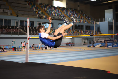 ISTANBUL, TURKEY - MARCH 14, 2021: Undefined athlete high jumping during Turkish Athletic Federation Municipalities Indoor Athletics Championshipsのeditorial素材