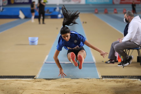 ISTANBUL, TURKEY - MARCH 14, 2021: Undefined athlete long jumping during Turkish Athletic Federation Municipalities Indoor Athletics Championshipsのeditorial素材