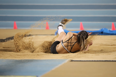 ISTANBUL, TURKEY - MARCH 07, 2021: Undefined athlete long jumping during Turkish Athletic Federation Combined Track and Field Competitions Championshipsのeditorial素材