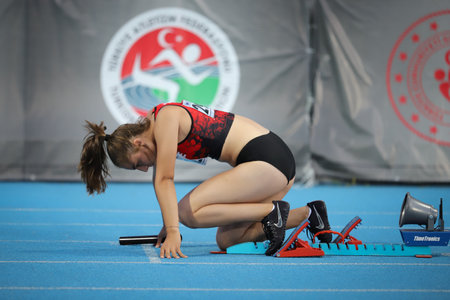 ISTANBUL, TURKEY - JUNE 12, 2021: Undefined athlete running running 4x100 metres relay during Balkan U20 Athletics Championshipsのeditorial素材