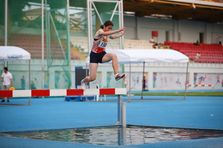 ISTANBUL, TURKEY - JUNE 23, 2021: Undefined athlete running 3000 metres steeplechase during Turkish Athletic Federation Cezmi Or Cupのeditorial素材