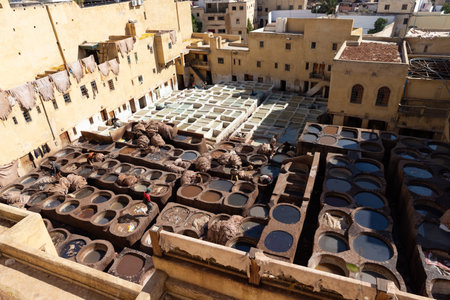 FEZ, MOROCCO - OCTOBER 31, 2021: People dyeing leather in Chouara Tannery where one of the most popular place to visit in Fez Cityのeditorial素材