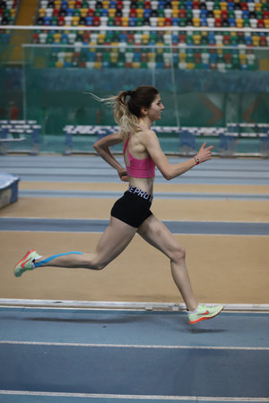 ISTANBUL, TURKEY - FEBRUARY 19, 2022: Undefined athlete running during Turkey Olympic Preparation Center Athletes Indoor Festival in Atakoy Athletics Arenaのeditorial素材