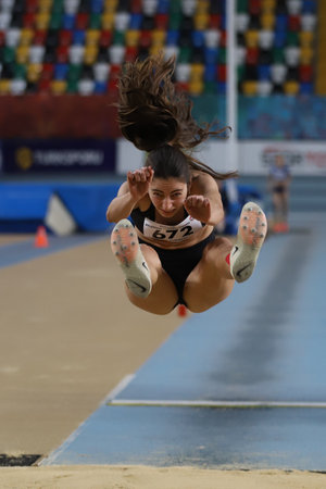 ISTANBUL, TURKEY - FEBRUARY 26, 2022: Undefined athlete long jumping during Turkish Indoor Athletics Championships in Atakoy Athletics Arenaのeditorial素材