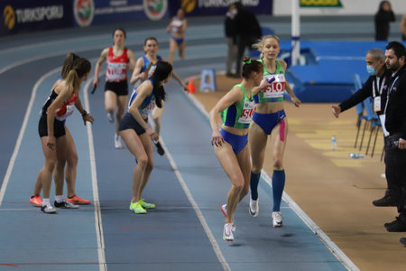 ISTANBUL, TURKEY - MARCH 05, 2022: Athletes running 4x400 metres relay during Balkan Athletics Indoor Championships in Atakoy Athletics Arenaのeditorial素材
