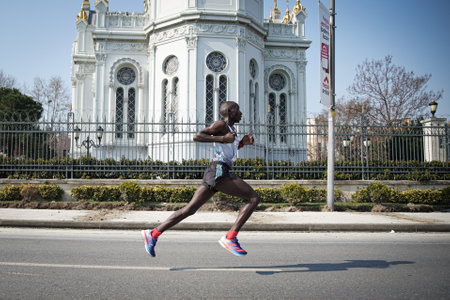 ISTANBUL, TURKEY - NOVEMBER 07, 2021: Athlete running Istanbul half marathon in historic street of Fener districtのeditorial素材