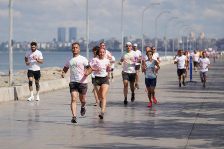 ISTANBUL, TURKIYE - JUNE 18, 2022: People running in colors during Color Run Maltepe 7K Run