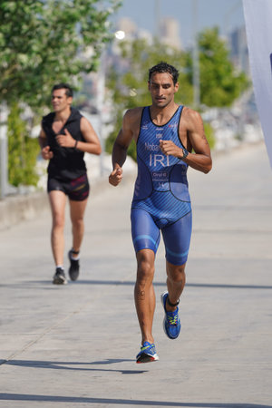 ISTANBUL, TURKIYE - JULY 02, 2022: Undefined athlete competing in running component of aquathlon during Maltepe Water Sports Festivalのeditorial素材